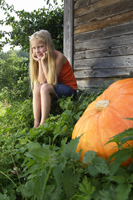 girl sitting next to pumpkin - Alex Mares-Manton