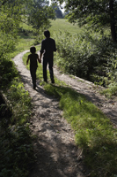 father and son walking down country road - Alex Mares-Manton