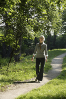 Senior woman walking on path - Alex Mares-Manton