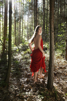 young woman in red dress walking in forest - Alex Mares-Manton