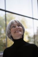 woman smiling up toward ceiling - Dennison Bertrand