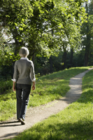 Senior woman walking on path - Alex Mares-Manton