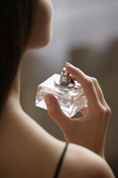 Young woman applying perfume - Alex Mares-Manton