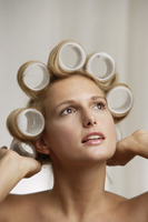 Young woman with curlers in hair - Alex Mares-Manton