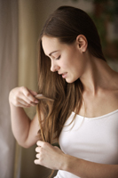 Young woman combing hair - Alex Mares-Manton