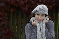 Young woman wrapped up warmly in scarf, hat and wool sweater - Alex Mares-Manton