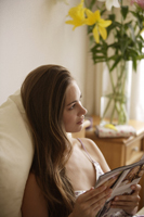 young woman reading magazine - Alex Mares-Manton