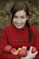 young woman holding arm full of apples - Alex Mares-Manton