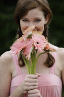Portrait of woman holding bouquet of flowers - Alex Mares-Manton