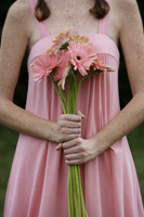 Woman holding bouquet of daisies - Alex Mares-Manton