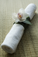 Spa towel wrapped in leaf and orchid - Nugene Chiang