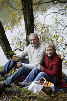 Senior couple having picnic in woods - Alex Mares-Manton