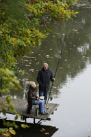 Senior couple fishing from wooden pier - Alex Mares-Manton