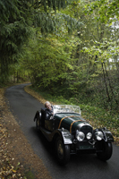 senior man driving down country road in antique car - Alex Mares-Manton