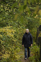 Senior man taking walk through woods - Alex Mares-Manton
