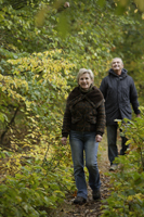 senior couple walking through woods - Alex Mares-Manton