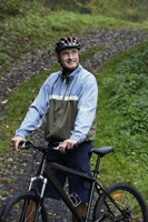 Senior man resting on bike ride - Alex Mares-Manton