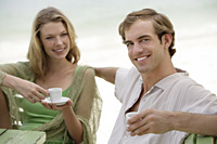 couple having coffee at beach cafe - Alex Mares-Manton