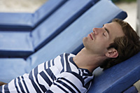 man reclining on beach chair - Alex Mares-Manton