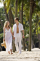 Couple walking on tropical beach - Alex Mares-Manton