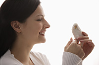 woman holding tiny bird - Nugene Chiang