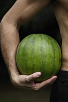 watermelon held in mans arm - Nugene Chiang