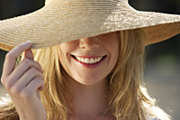 portrait of woman smiling under big hat - Alex Mares-Manton