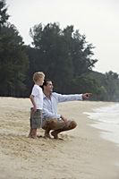 father and son on beach - Nugene Chiang