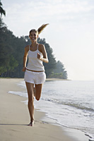 woman running on beach - Nugene Chiang