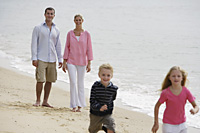 family walking on beach - Nugene Chiang