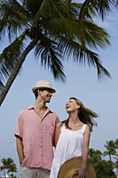 couple standing under palm tree - Alex Mares-Manton