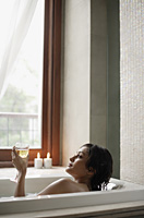woman in bathtub with glass of wine - Alex Mares-Manton