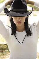 woman wearing black cowboy hat - Nugene Chiang