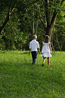 boy and girl walking through park - Nugene Chiang