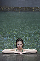 woman resting inside pool, resting on deck - Alex Mares-Manton