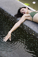 woman reclining poolside - Alex Mares-Manton