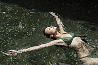 woman floating on back in pool - Alex Mares-Manton