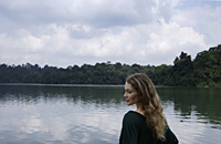 Profile of woman standing near lake - Nugene Chiang