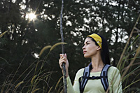 woman hiking in tall grass - Nugene Chiang