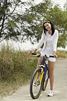 young woman riding bike - Nugene Chiang
