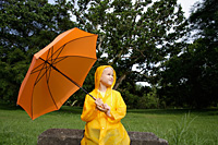 Young boy with orange umbrella - Nugene Chiang