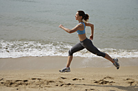 woman running on beach - Nugene Chiang