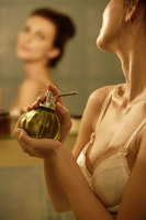 Young woman applying fragrance - Alex Mares-Manton