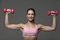 Woman working out with weights - Nugene Chiang