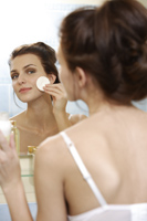 Young woman applying cosmetics - Alex Mares-Manton