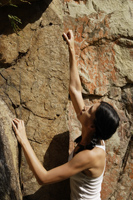 Young woman climbing rock - Nugene Chiang