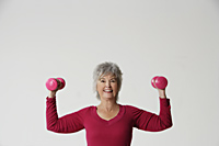 Mature woman lifting weights. - Nugene Chiang