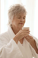 Older woman enjoying her tea. - Nugene Chiang