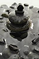 Rocks stacked on each other in water. - Nugene Chiang