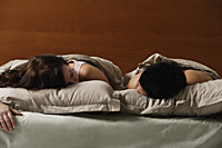 man and woman sleeping in bed together - Nugene Chiang